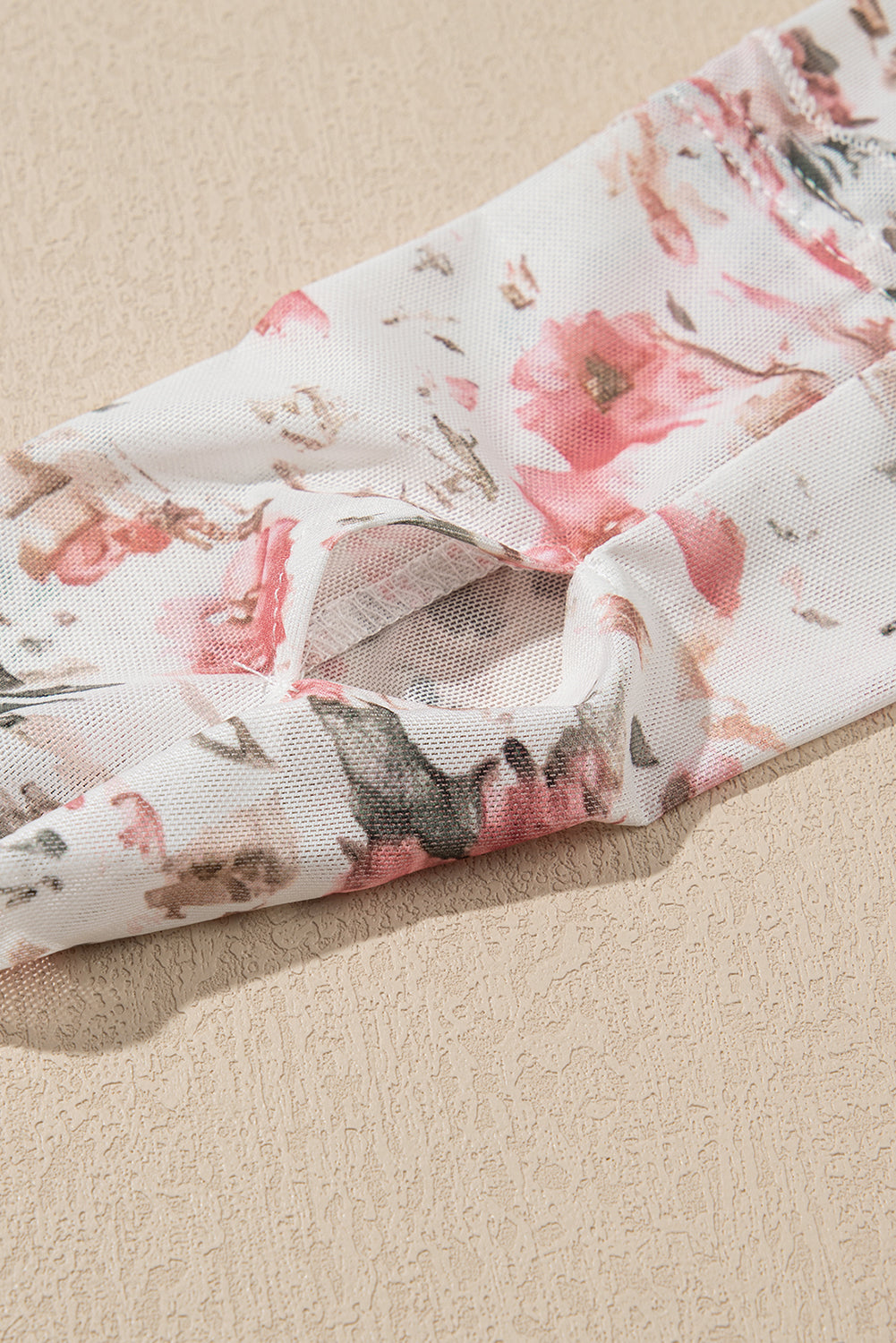 Pink Floral Long Sleeve Mesh Top with thumbholes.